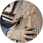 round image of gloved hands working on house