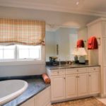 master ensuite bathroom with white cabinet and black counter tops