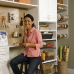 woman in garage with custom shelving unit for tool bench
