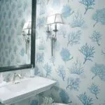 updated bathroom with blue and white wallpaper and large vanity mirror