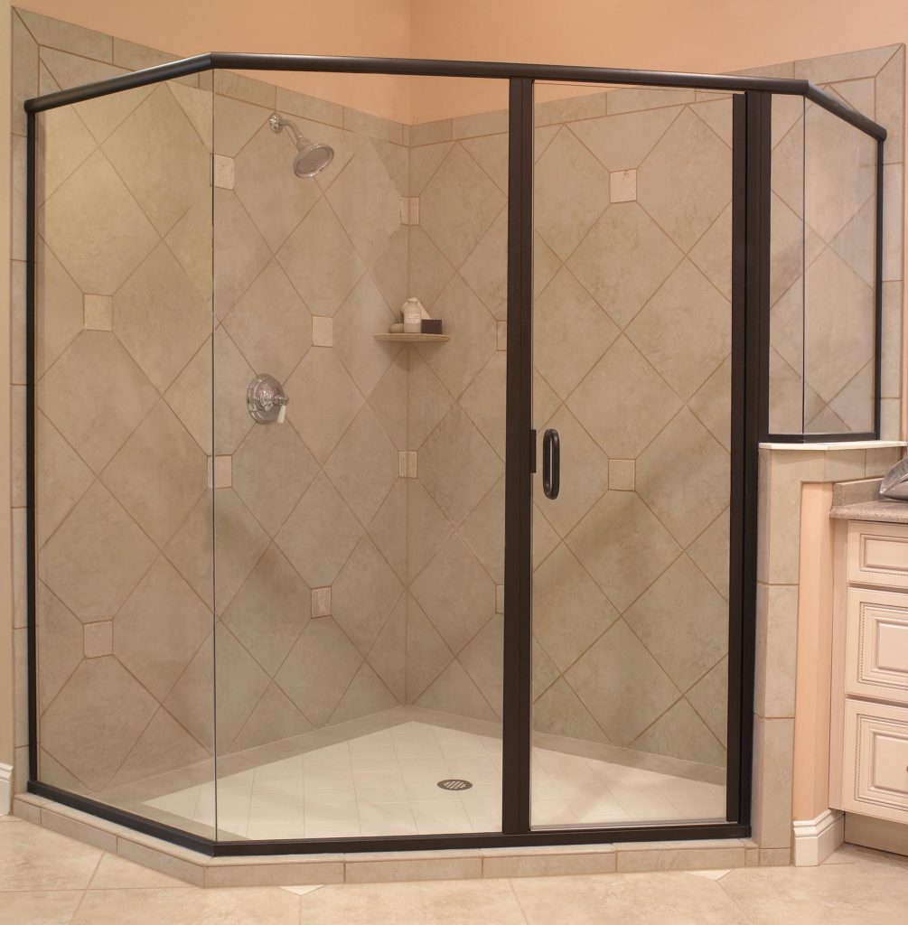 large walk in shower with glass door and tan tile