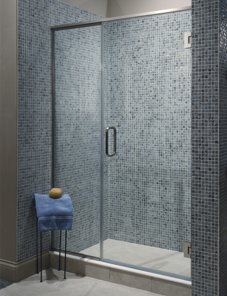 luxurious high end walk in shower with blue tile and glass door
